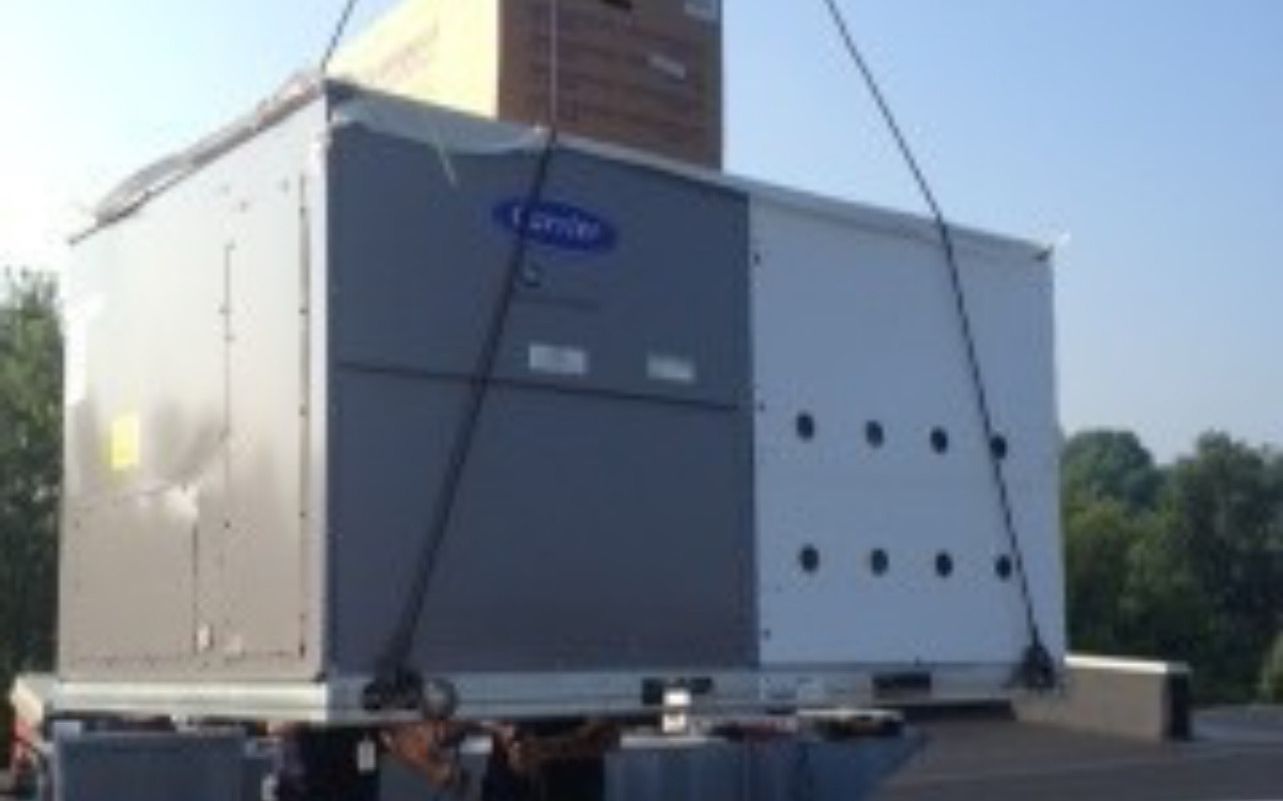 Commercial rooftop HVAC unit craned into place in Laredo