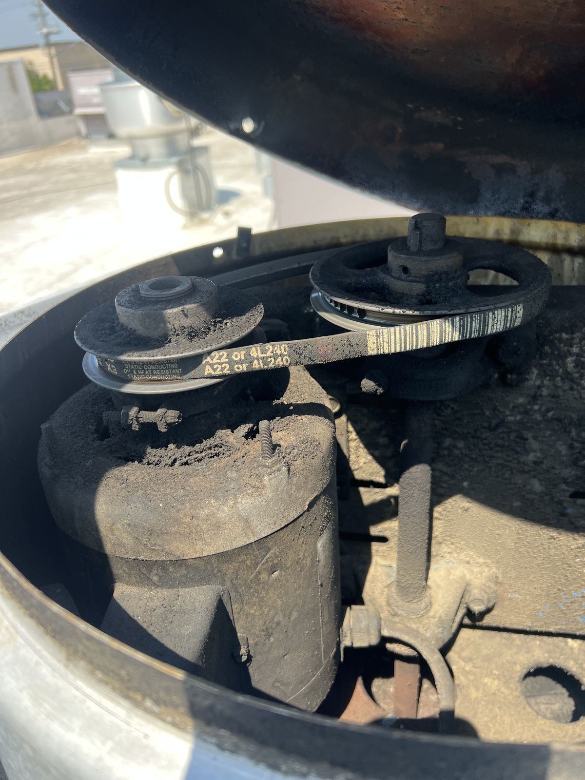 Interior fan motor assembly inside a commercial rooftop HVAC unit