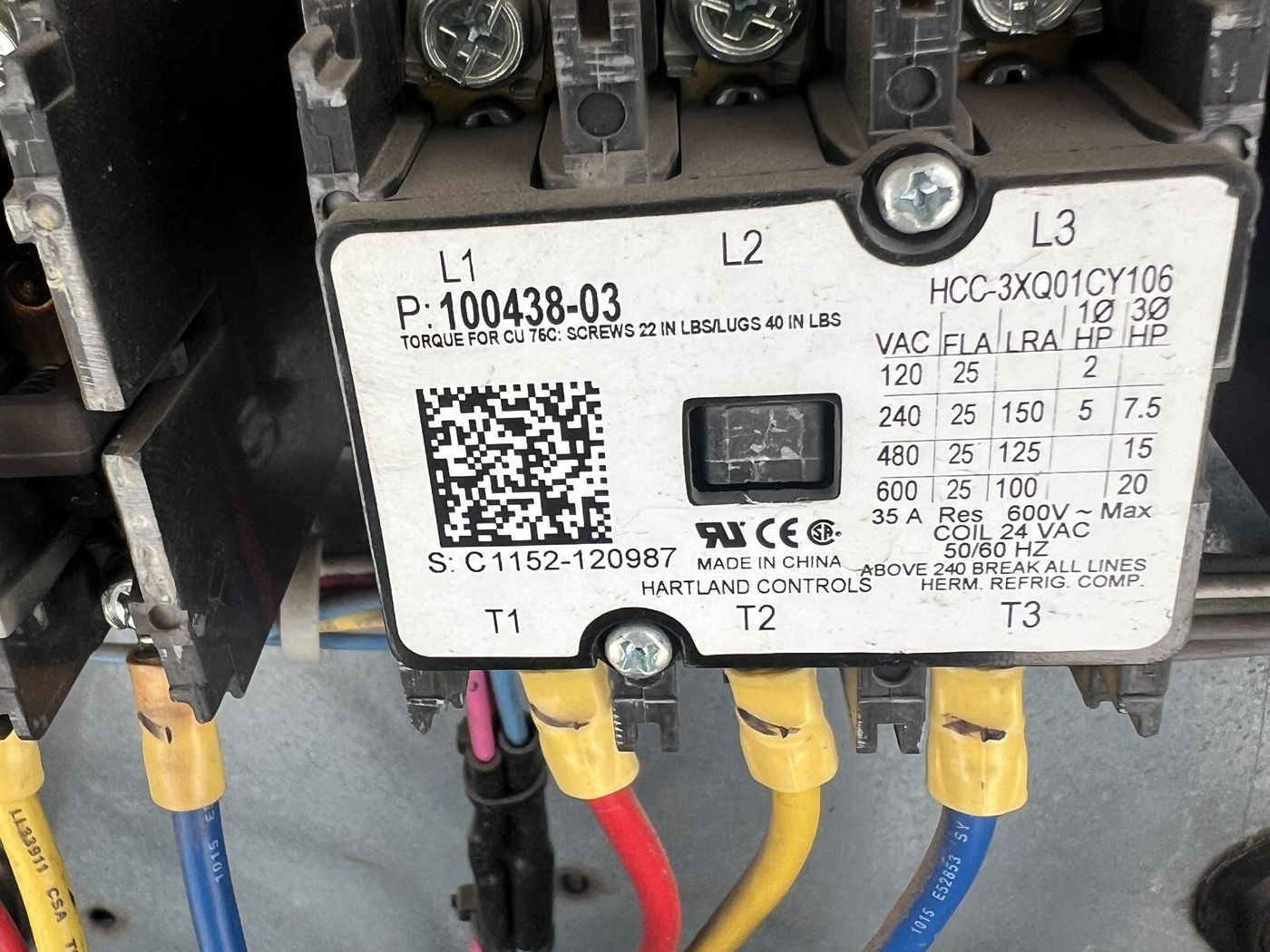 Guardian Air technician inspecting commercial electrical wiring and controls